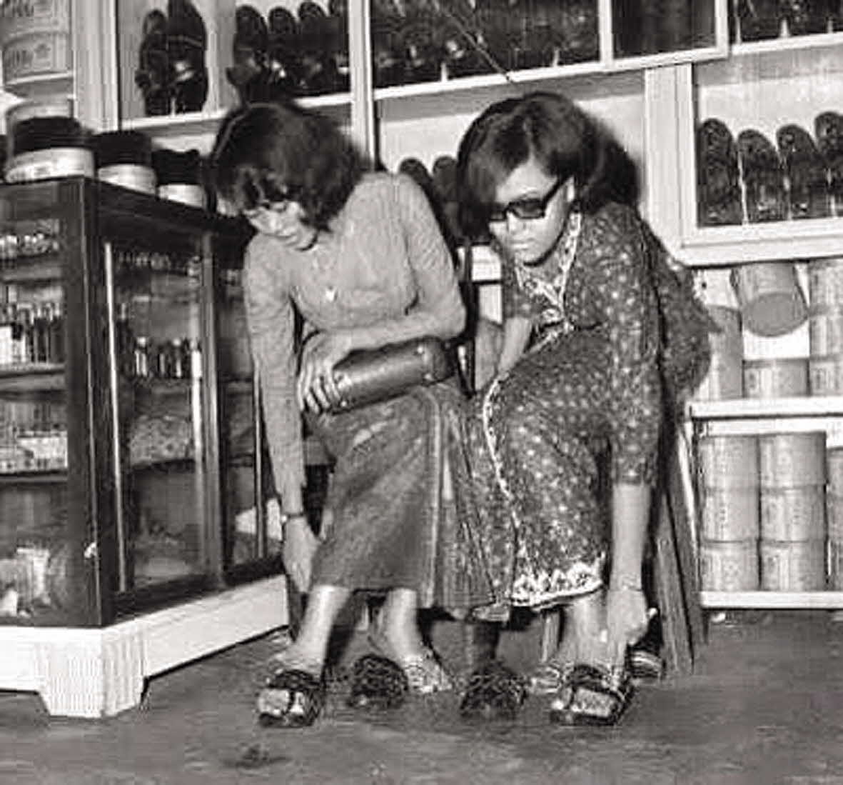 Ladies trying out H. M. Ali's shoes, mid-late 1900s